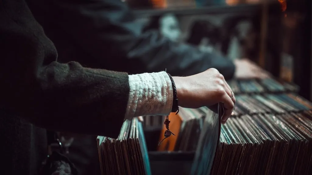 close-up hand person browsing vinyl